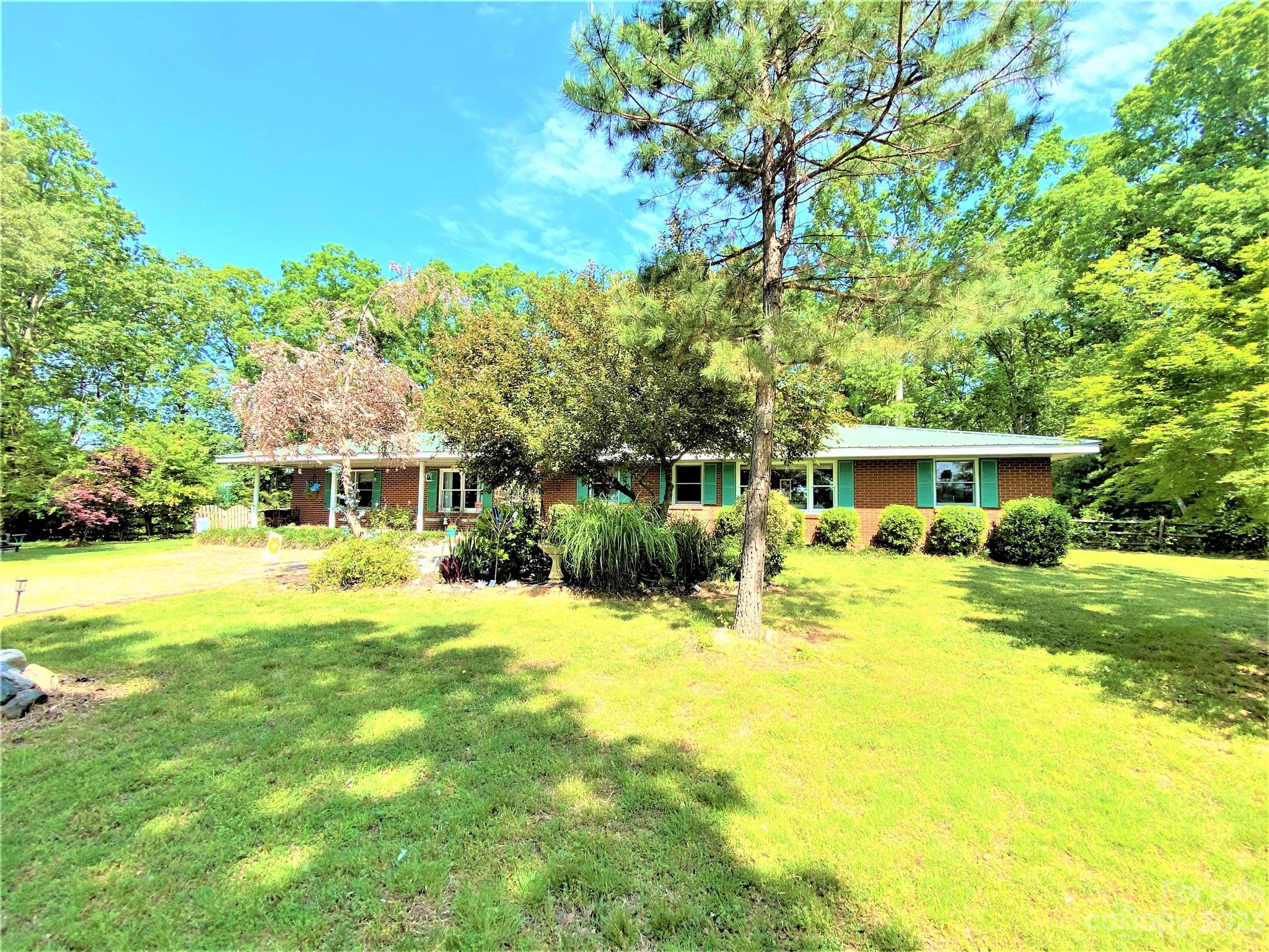 a front view of house with yard and green space
