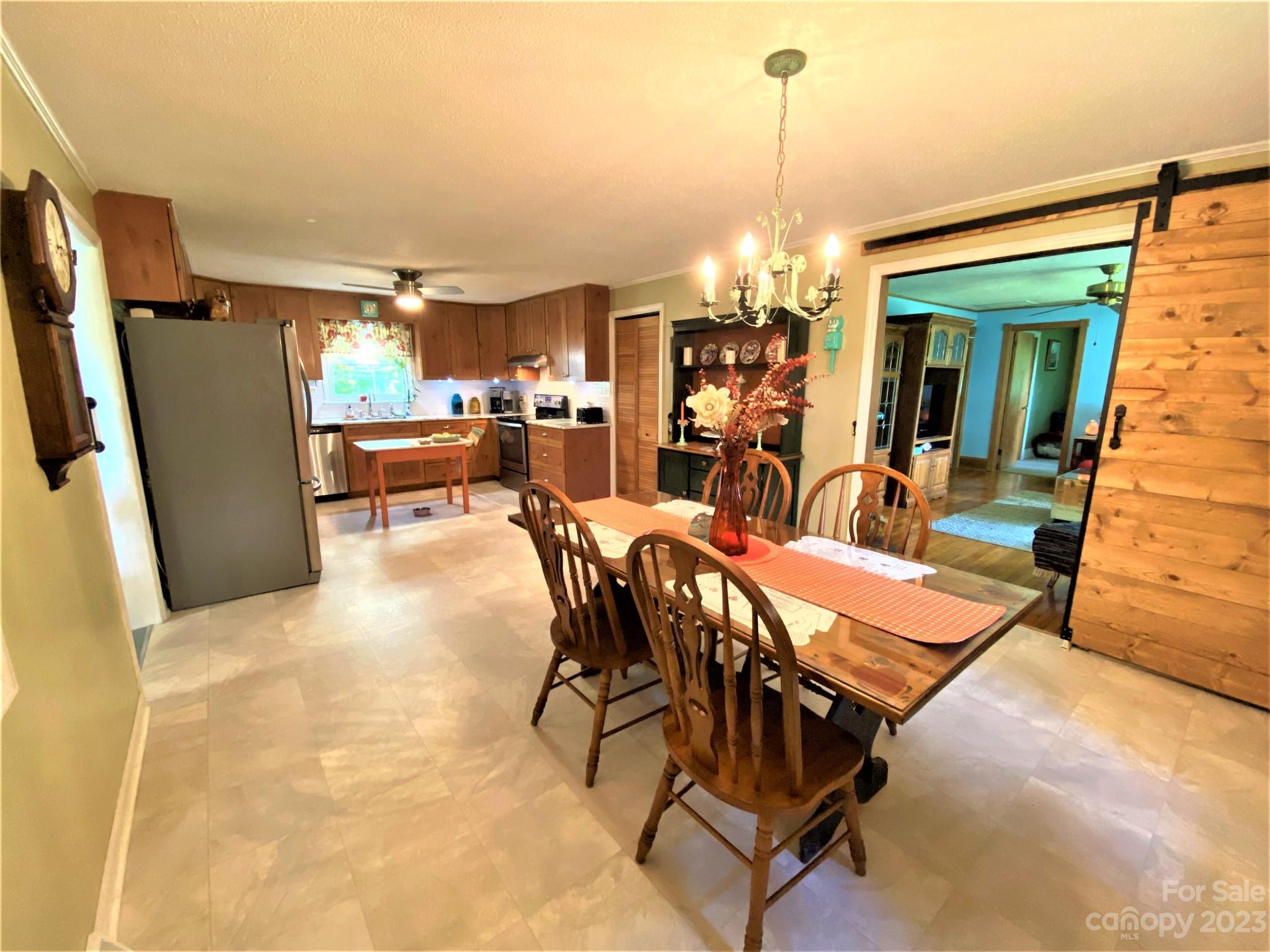 1203 Zeb Helms Road Monroe, NC 28112 - Photo 15 of 46 a dining room with furniture and a chandelier