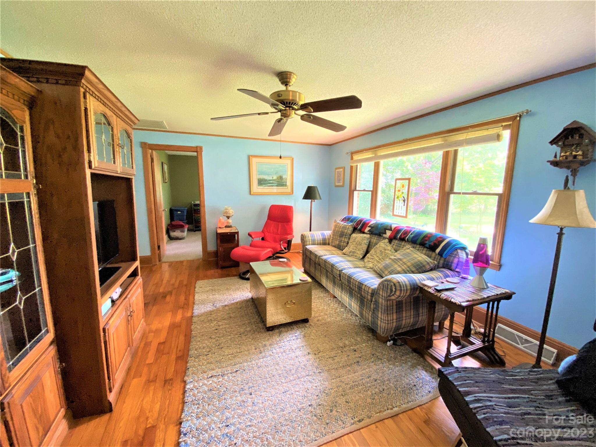 1203 Zeb Helms Road Monroe, NC 28112 - Photo 17 of 46 a living room with furniture a flat screen tv and a large window