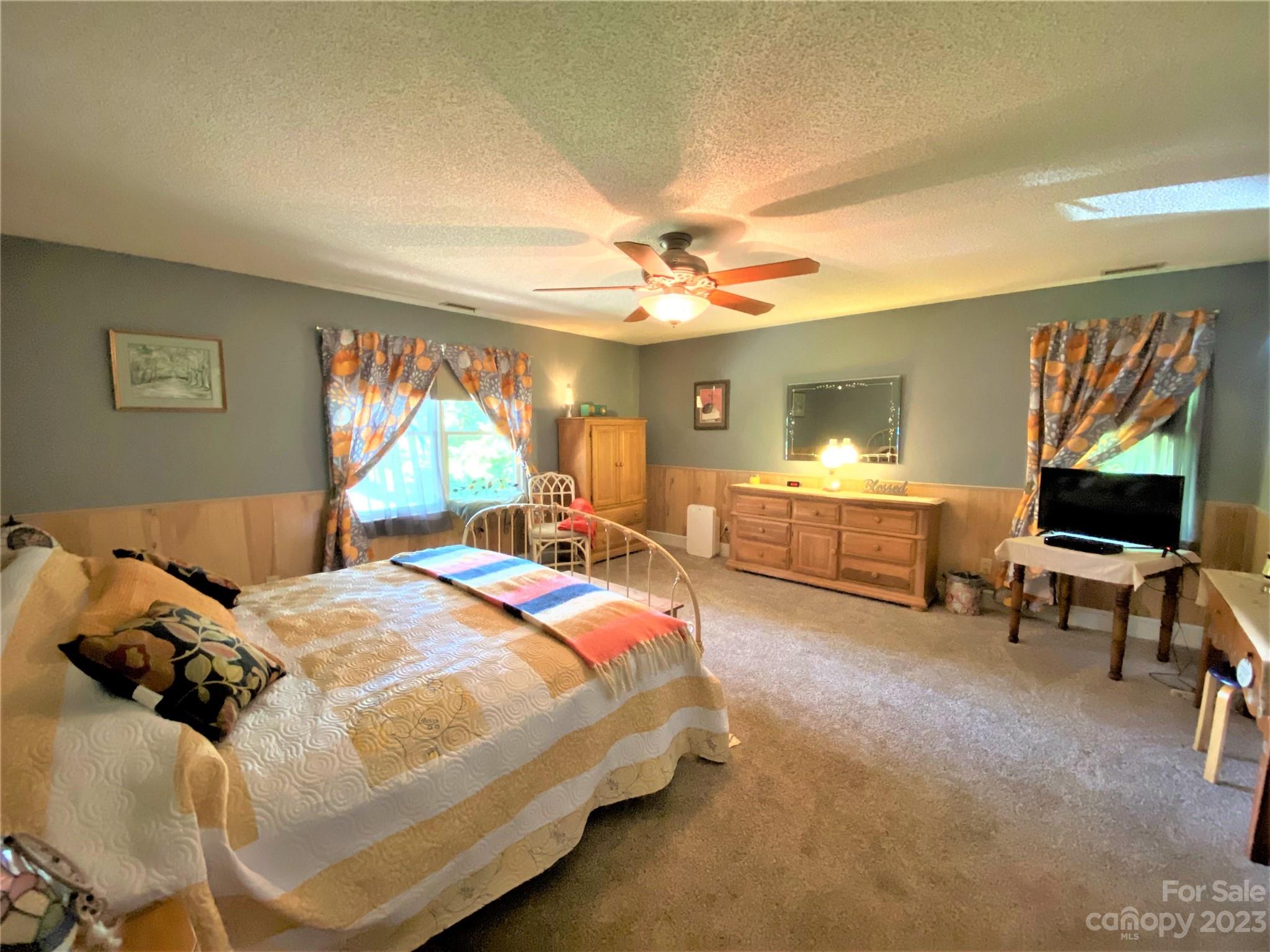 1203 Zeb Helms Road Monroe, NC 28112 - Photo 22 of 46 a bedroom with a bed and a chandelier