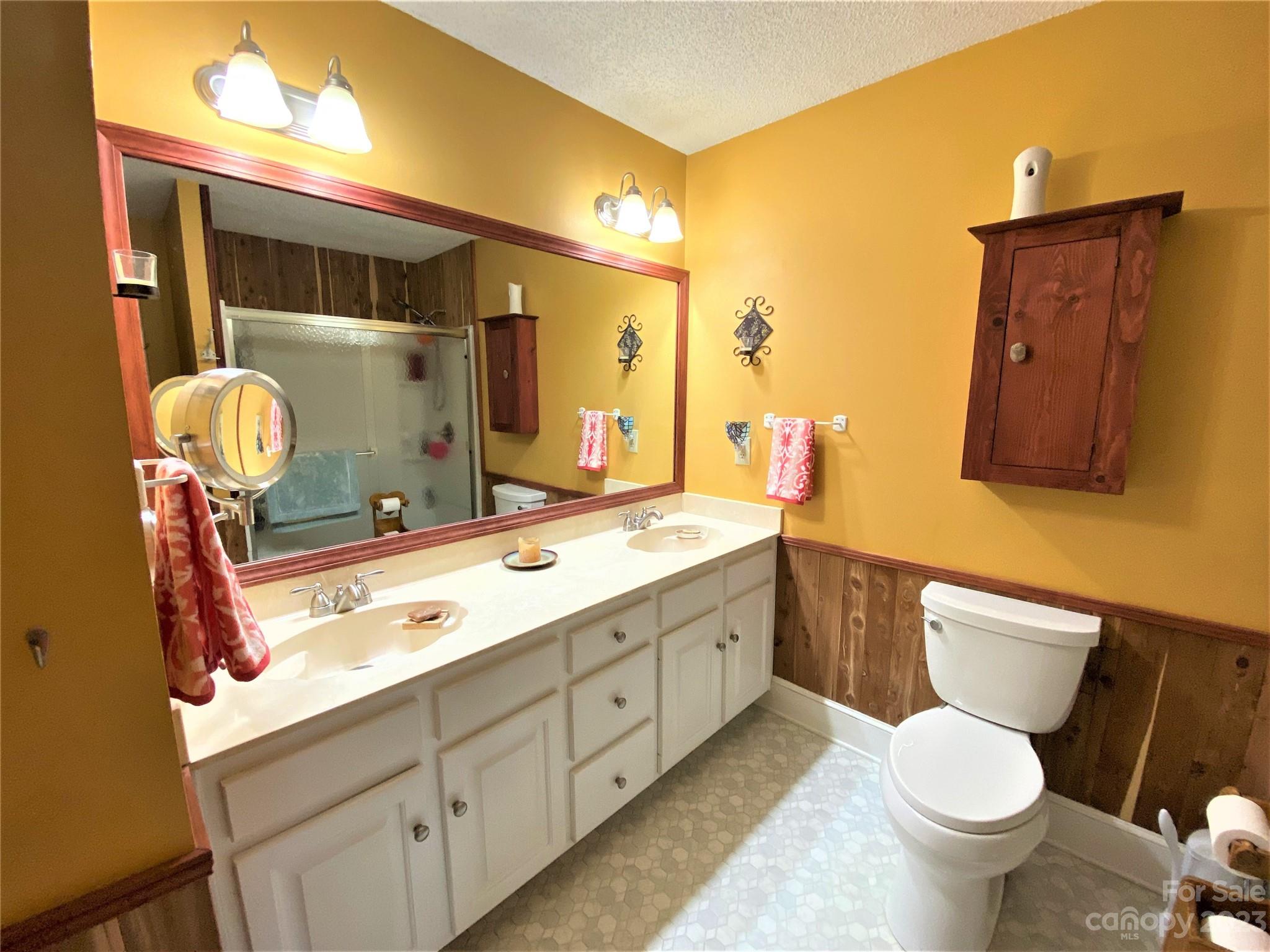 1203 Zeb Helms Road Monroe, NC 28112 - Photo 26 of 46 a bathroom with a toilet sink and mirror