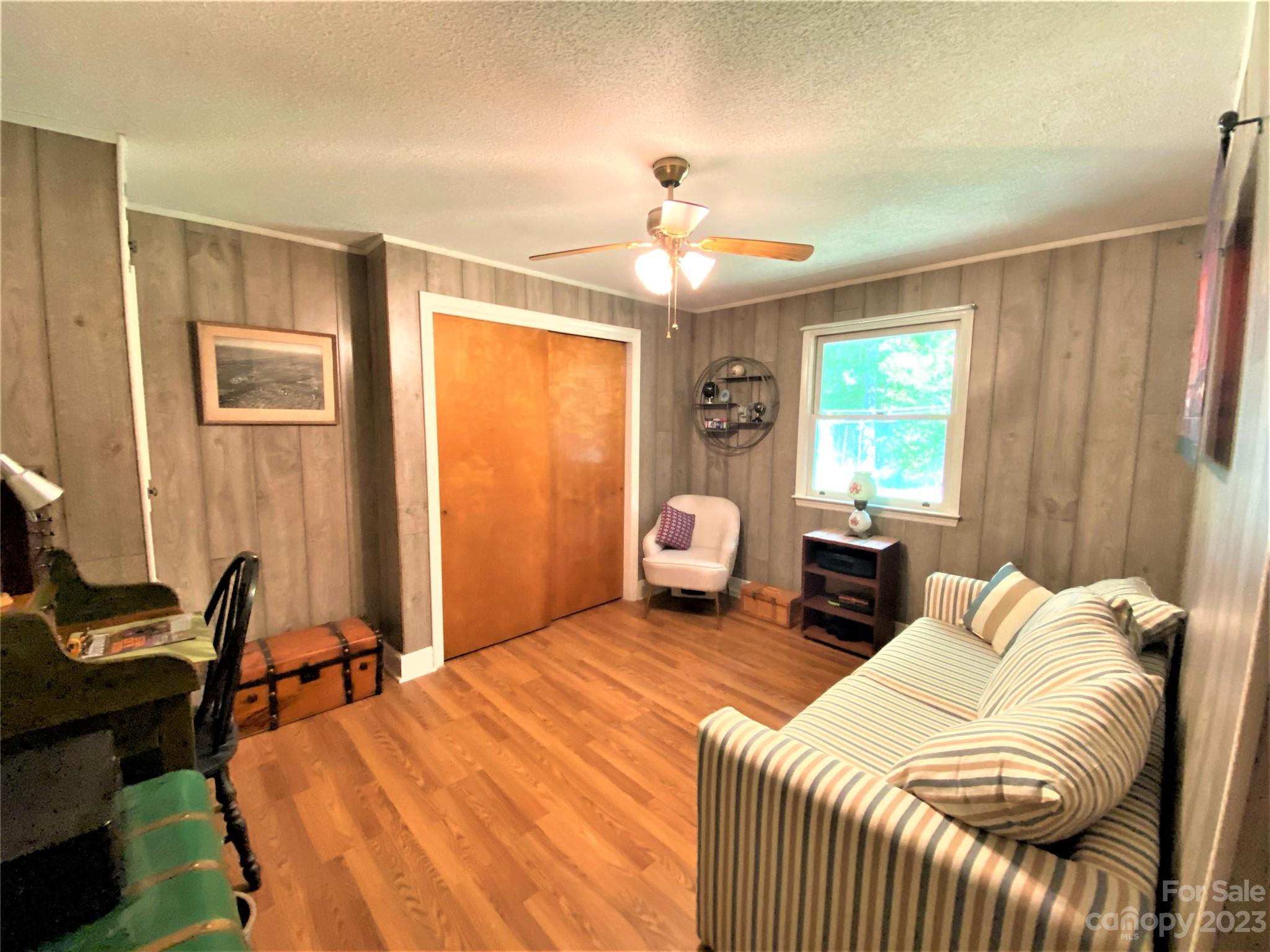 1203 Zeb Helms Road Monroe, NC 28112 - Photo 34 of 46 a bedroom with a bed and a chandelier