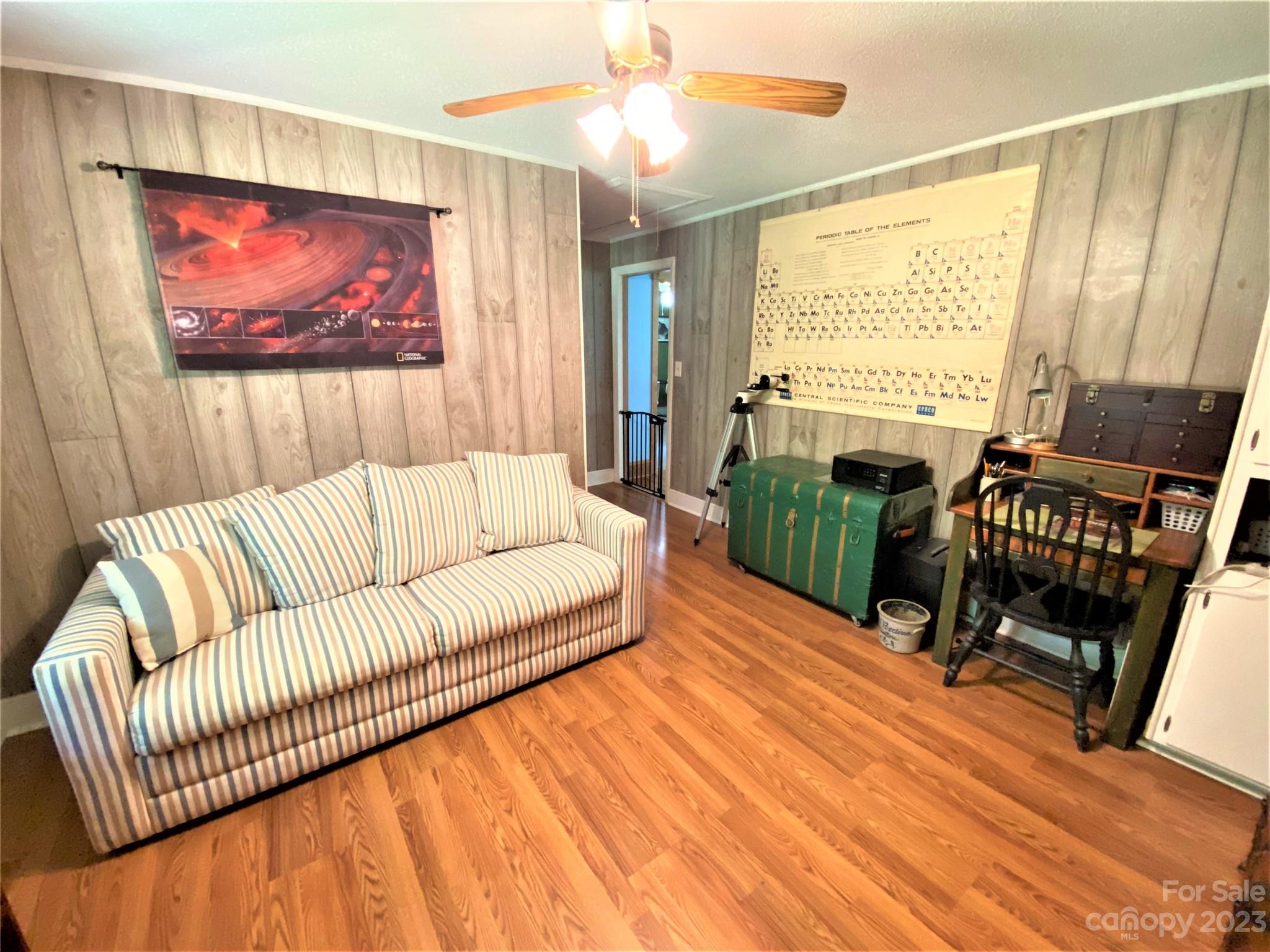 1203 Zeb Helms Road Monroe, NC 28112 - Photo 36 of 46 a living room with furniture a large window and wooden floor