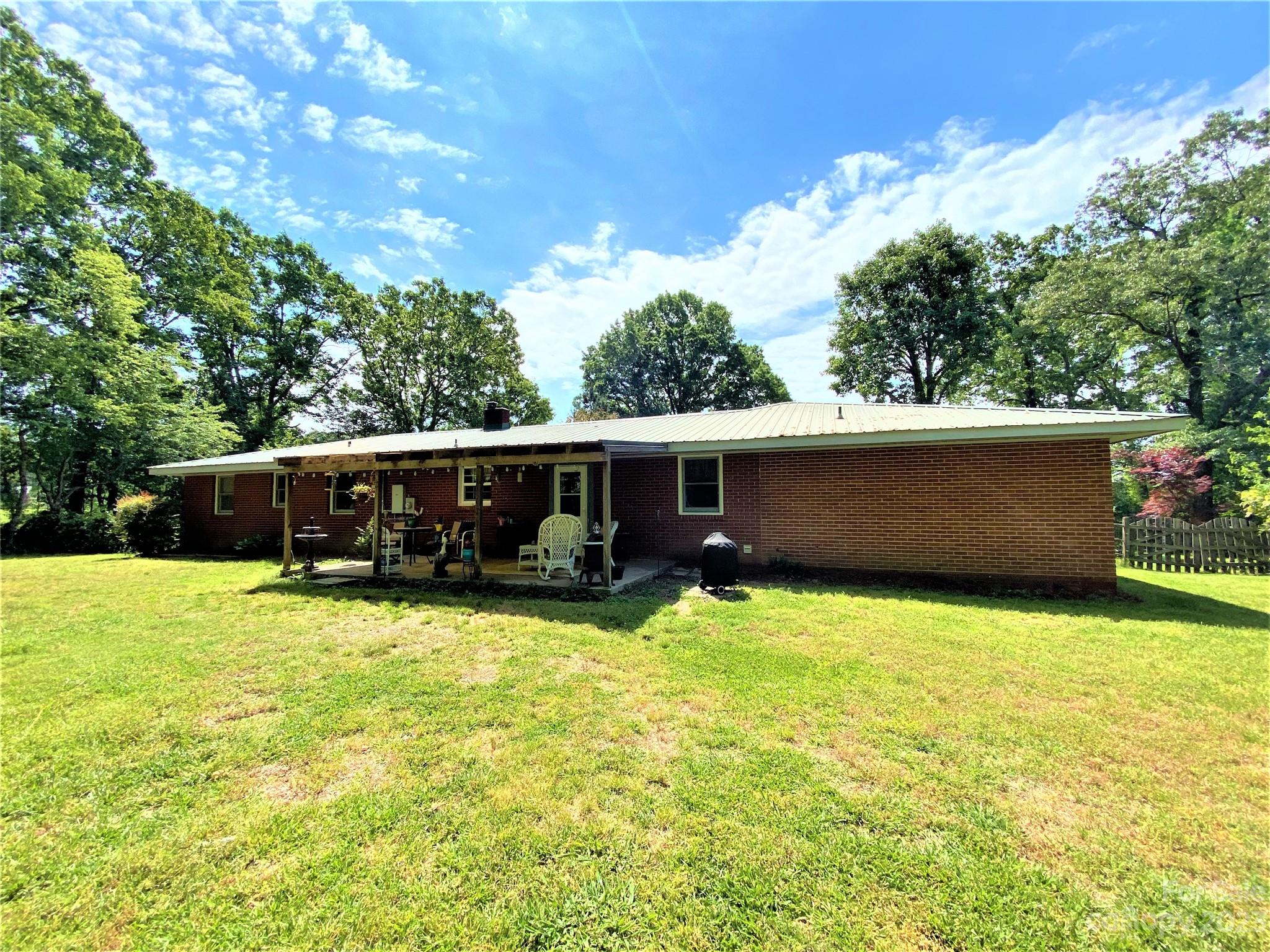 1203 Zeb Helms Road Monroe, NC 28112 - Photo 39 of 46 a view of a house with backyard and sitting area
