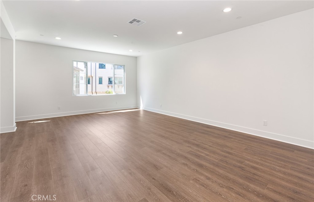 150 Bridle Drive Burbank, CA 91506 - Photo 13 of 36 an empty room with wooden floor and window