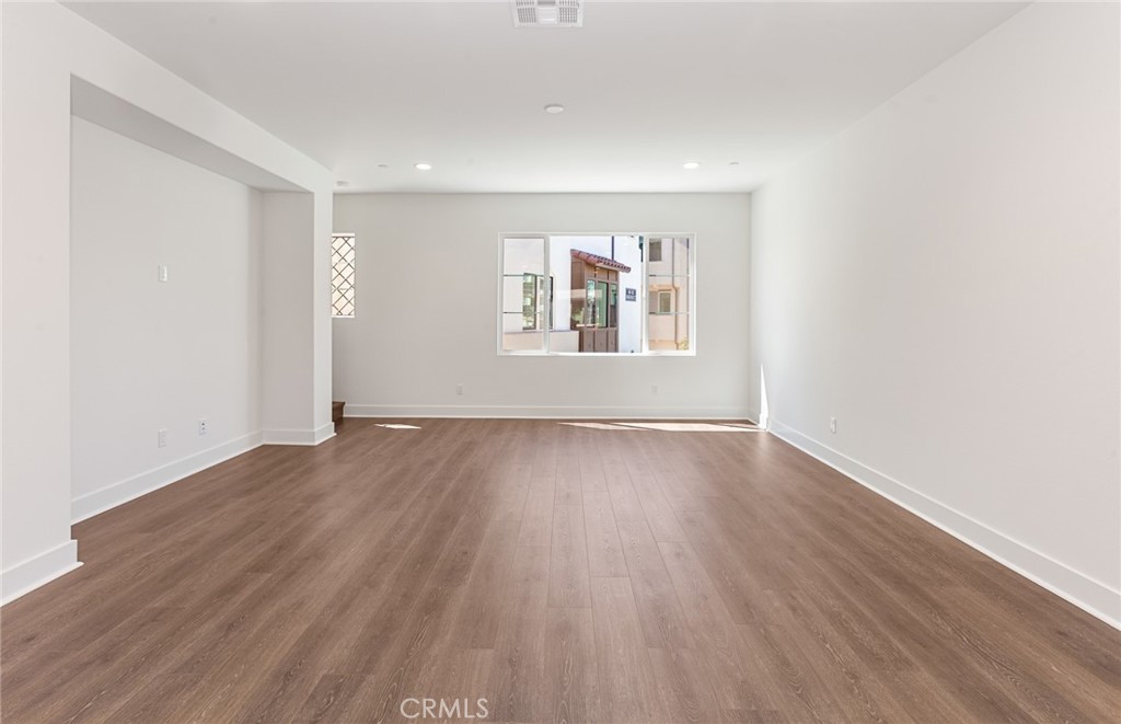150 Bridle Drive Burbank, CA 91506 - Photo 14 of 36 an empty room with wooden floor and windows