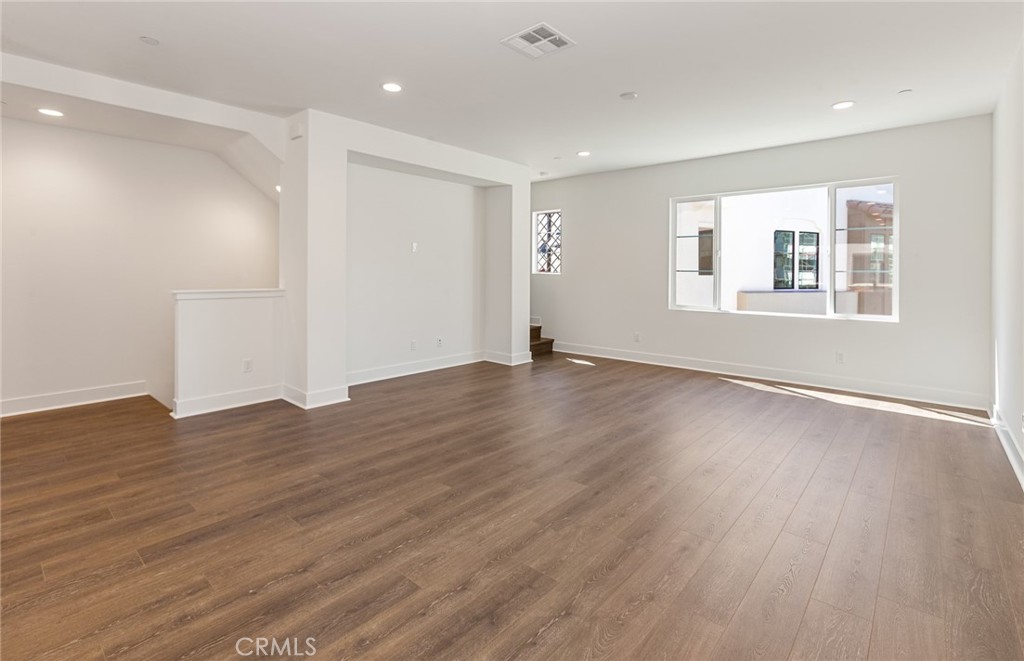 150 Bridle Drive Burbank, CA 91506 - Photo 15 of 36 a view of an empty room with wooden floor and windows