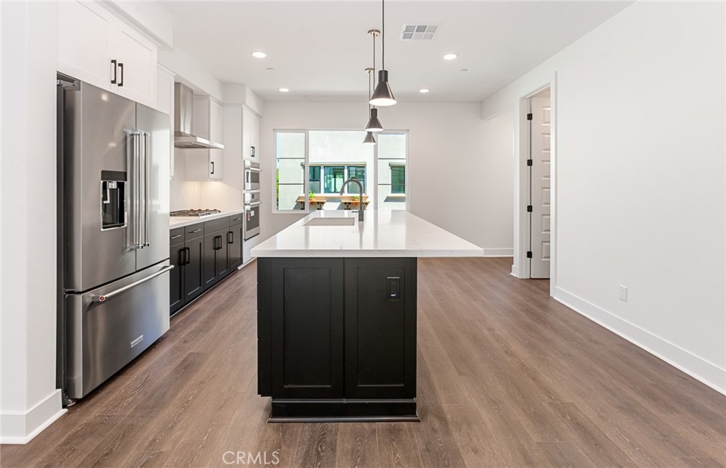 150 Bridle Drive Burbank, CA 91506 - Photo 19 of 36 a kitchen with kitchen island a counter top space a sink and stainless steel appliances
