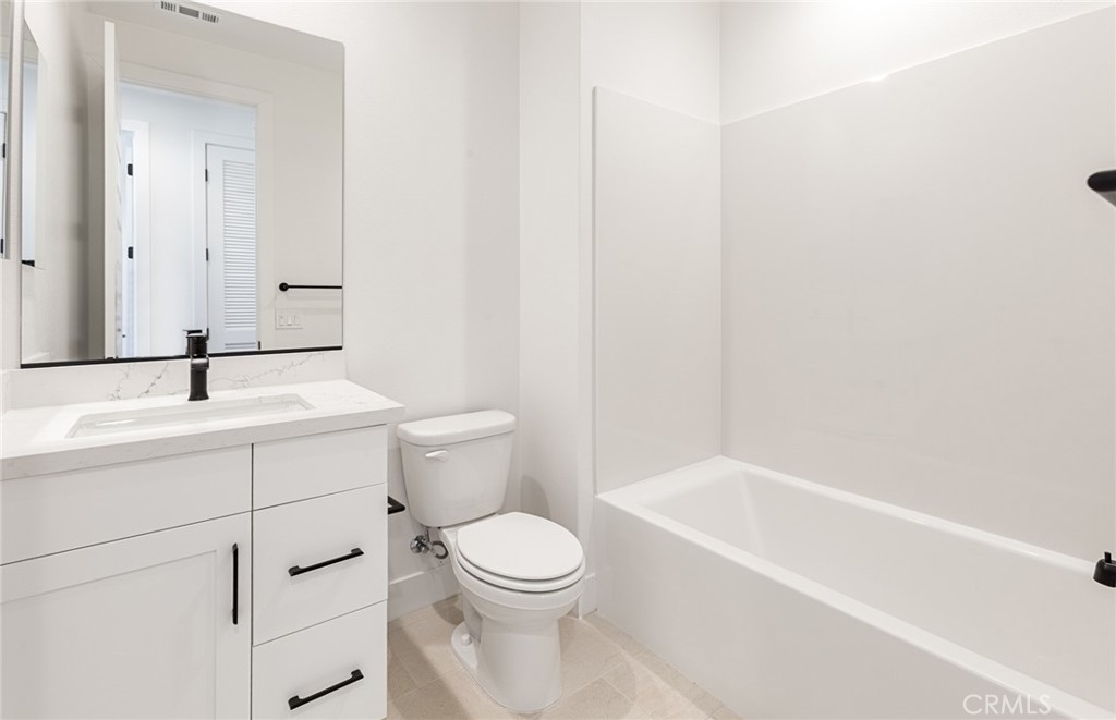 150 Bridle Drive Burbank, CA 91506 - Photo 30 of 36 a bathroom with a toilet a sink a mirror and bathtub