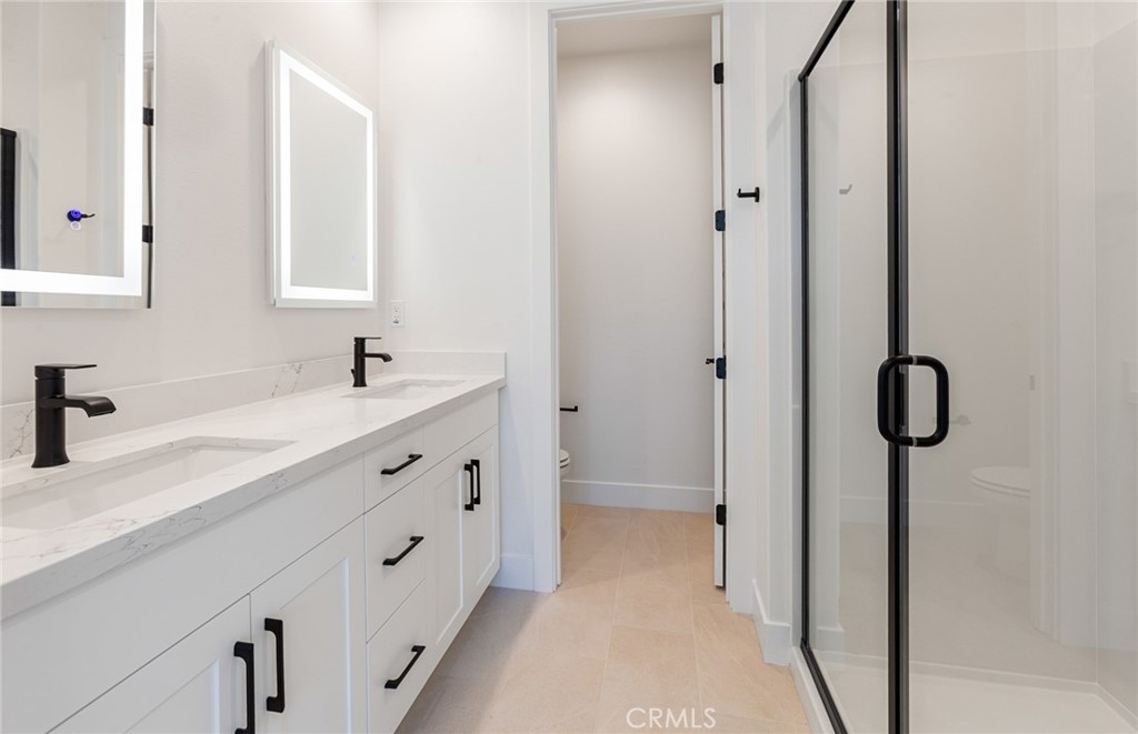 150 Bridle Drive Burbank, CA 91506 - Photo 35 of 36 a spacious bathroom with a double vanity sink a mirror and shower