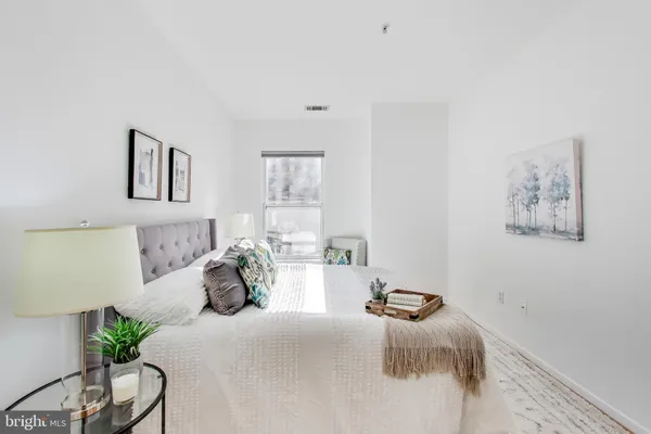 a bedroom with a bed and a couch