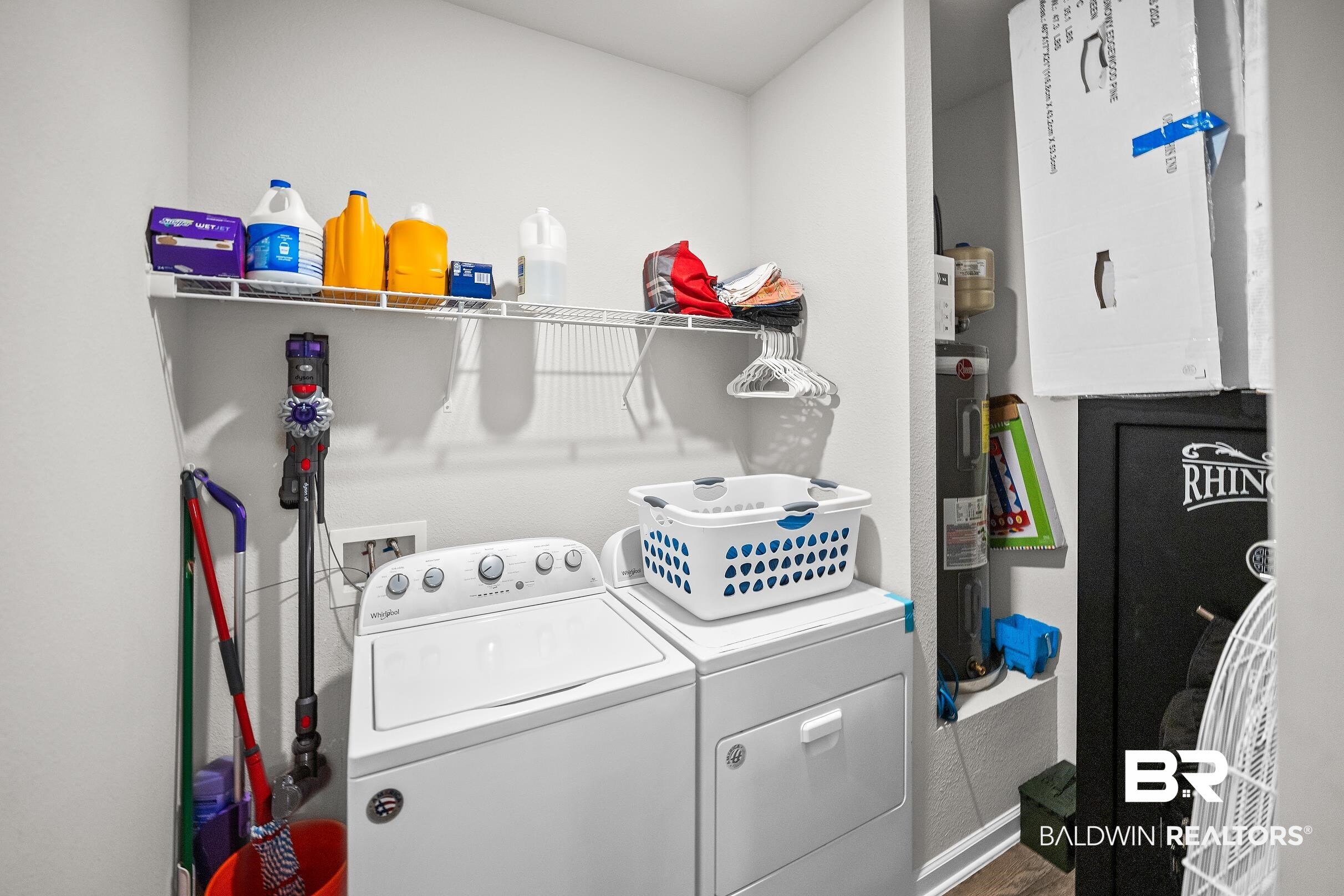23997 Veranda Circle Elberta, AL 36530 - Photo 22 of 28 Dedicated laundry area featuring a washer and dryer, an overhead wire shelving unit, and wood-finish flooring