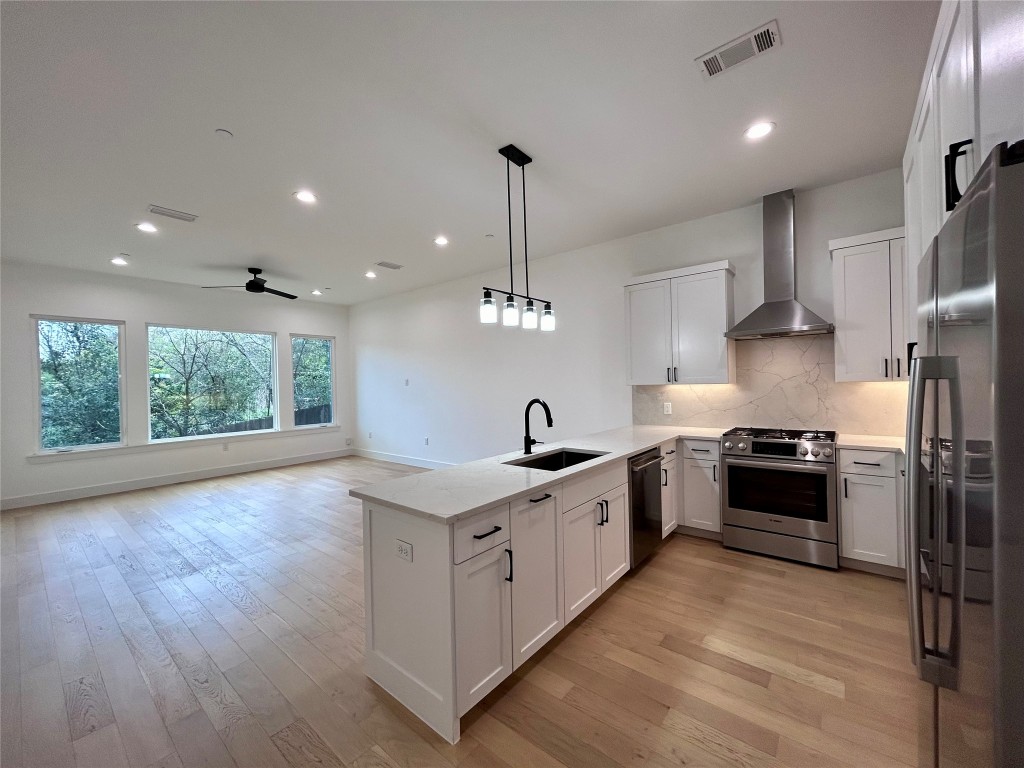 4010 Clawson Road, Unit 5 Austin, TX 78704 - Photo 1 of 1 a large kitchen with stainless steel appliances granite countertop a stove a sink and a refrigerator