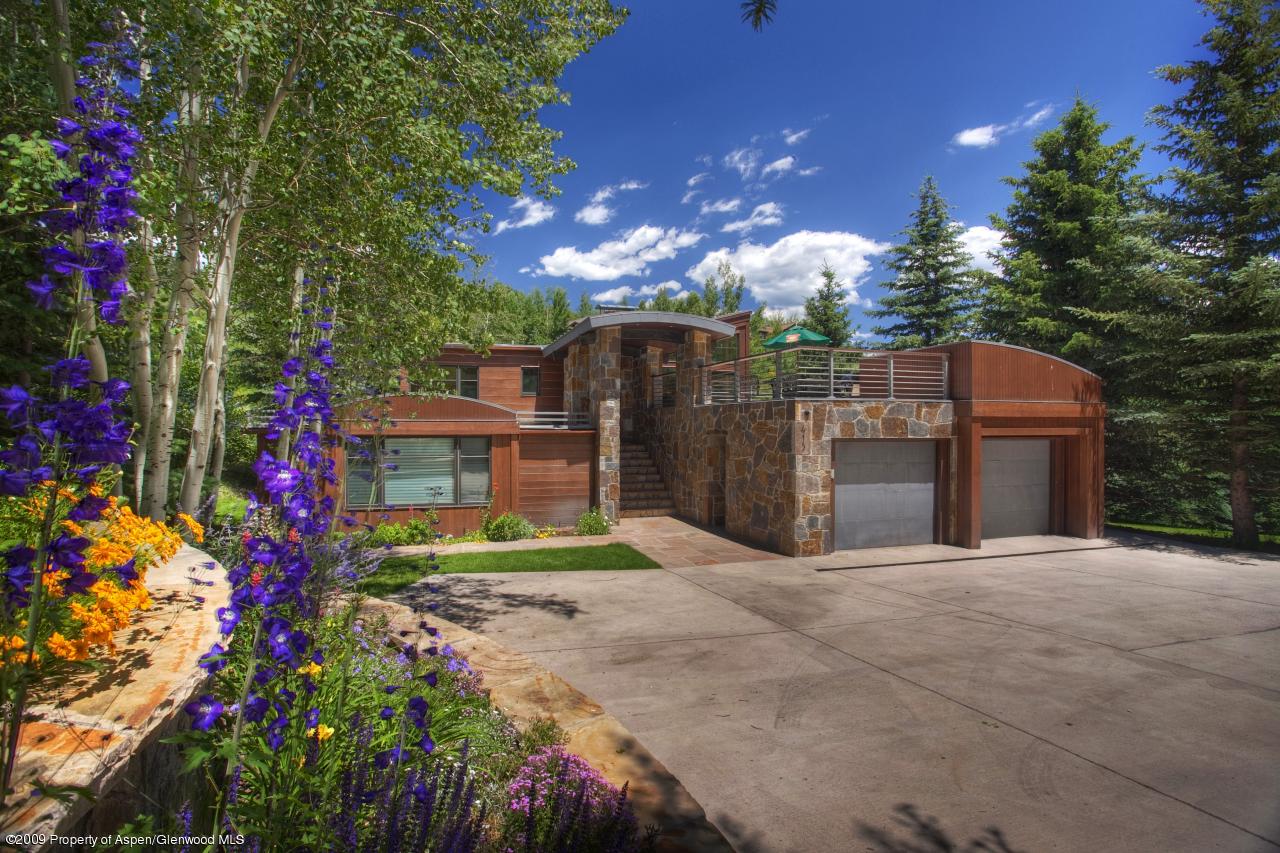 415 Meadow Road, Unit MELTON RANCH Snowmass Village, CO 81615 - Photo 1 of 18 a view of a house with a flower garden