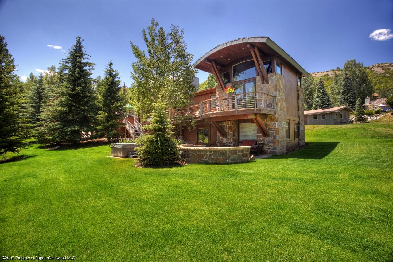 415 Meadow Road, Unit MELTON RANCH Snowmass Village, CO 81615 - Photo 12 of 18 a view of a house with backyard