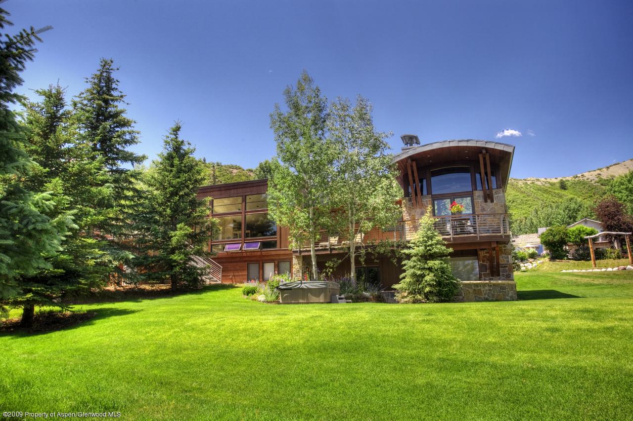 415 Meadow Road, Unit MELTON RANCH Snowmass Village, CO 81615 - Photo 13 of 18 a front view of a house with garden