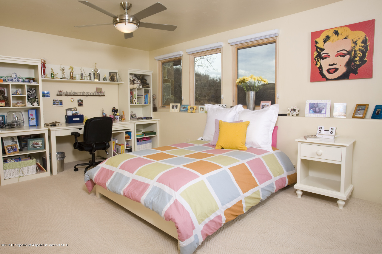 415 Meadow Road, Unit MELTON RANCH Snowmass Village, CO 81615 - Photo 17 of 18 a bedroom with a bed and a couch
