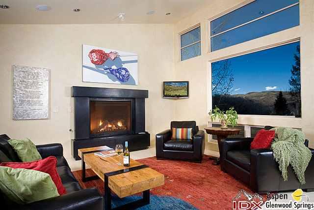 415 Meadow Road, Unit MELTON RANCH Snowmass Village, CO 81615 - Photo 2 of 18 a living room with furniture a flat screen tv and a fireplace