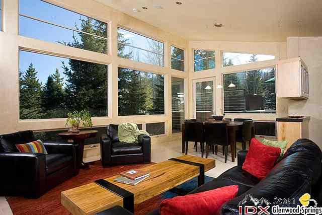 415 Meadow Road, Unit MELTON RANCH Snowmass Village, CO 81615 - Photo 8 of 18 a living room with furniture fireplace and large windows