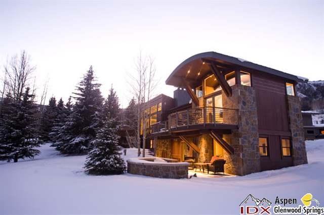 415 Meadow Road, Unit MELTON RANCH Snowmass Village, CO 81615 - Photo 9 of 18 a view of a house with a big yard