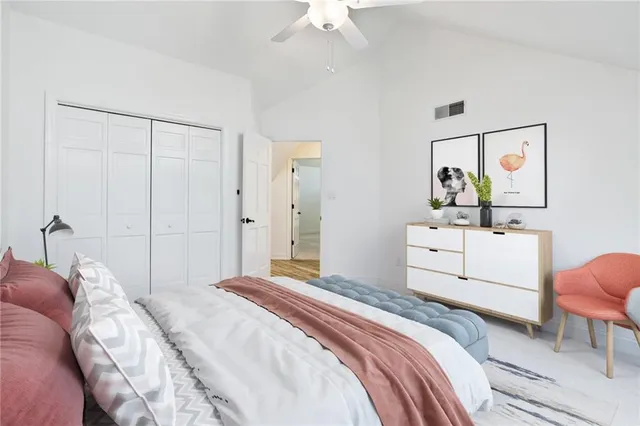 a bedroom with a white bed and a chandelier