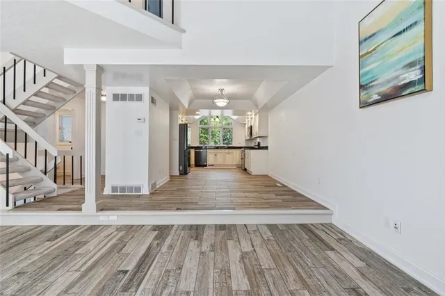 a view of entryway and hall with wooden floor