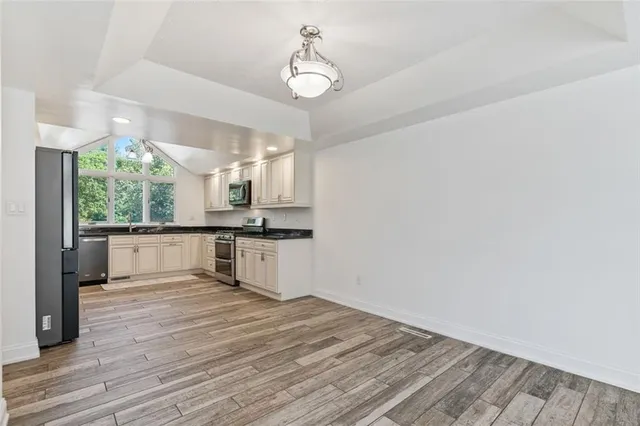 a view of kitchen with sink and wooden floor