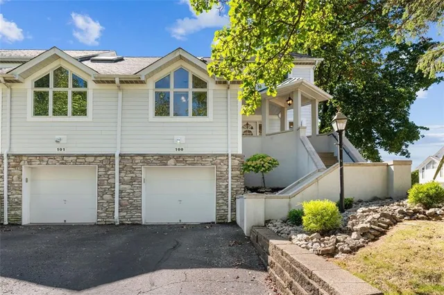 a front view of a house with potted plants