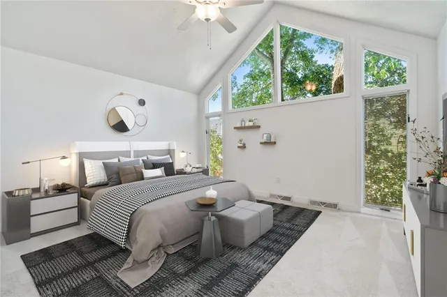 a bedroom with a bed and a large window