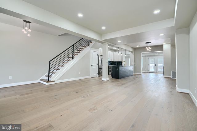 a kitchen with stainless steel appliances granite countertop a sink refrigerator and cabinets