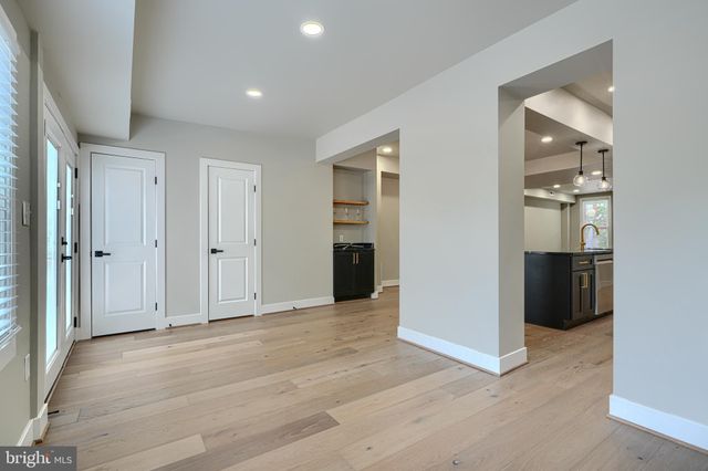a view of a room with wooden floor
