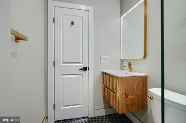 a view of a kitchen with a sink and dishwasher a refrigerator with wooden floor