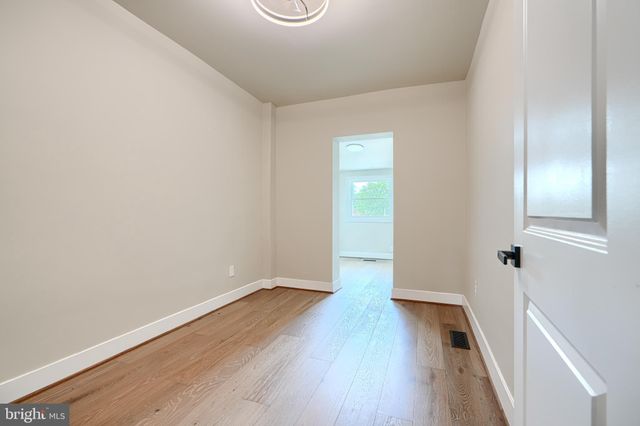 a kitchen with stainless steel appliances a refrigerator and a wooden floors