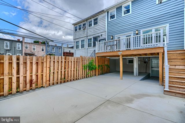 a view of a kitchen with granite countertop a stove and a wooden floors