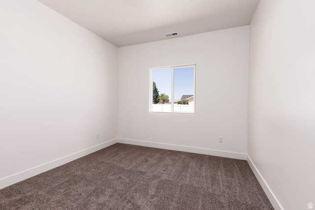 51 West 500 South Monroe, UT 84754 - Photo 9 of 41 Neutral white walls complementing dark gray carpeting, trimmed with white baseboards