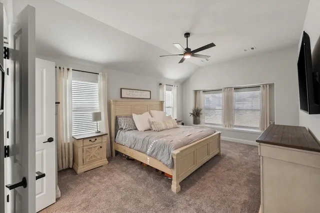 a bedroom with a bed dresser and a window