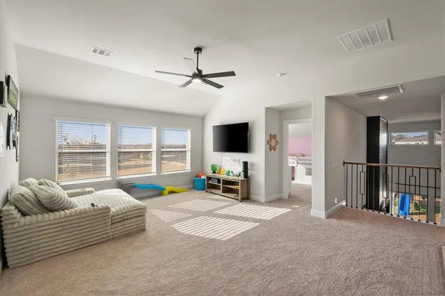 a bedroom with furniture and a large window