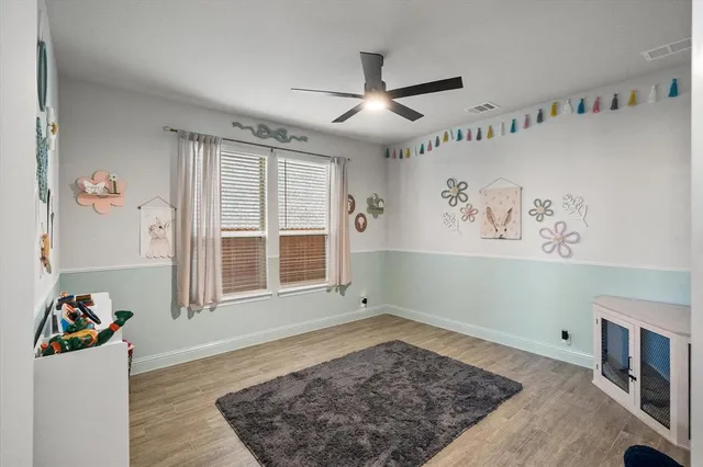 a view of a livingroom with wooden floor and a window