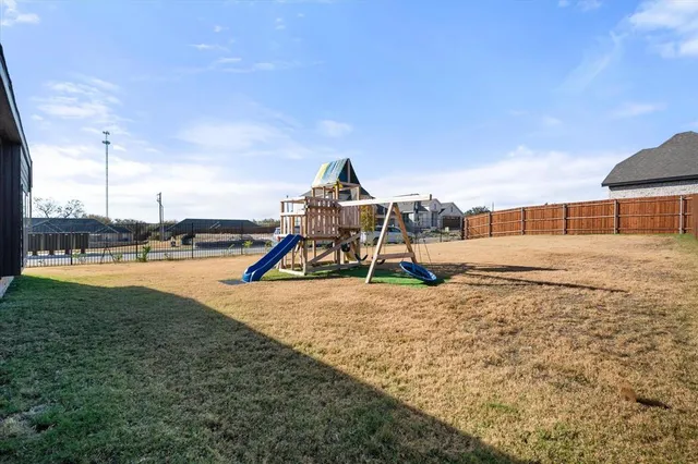 a view of a playground with a tree