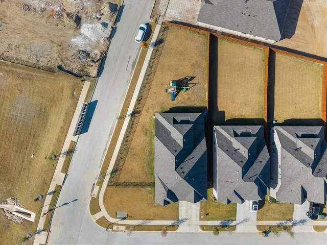an aerial view of residential houses with outdoor space