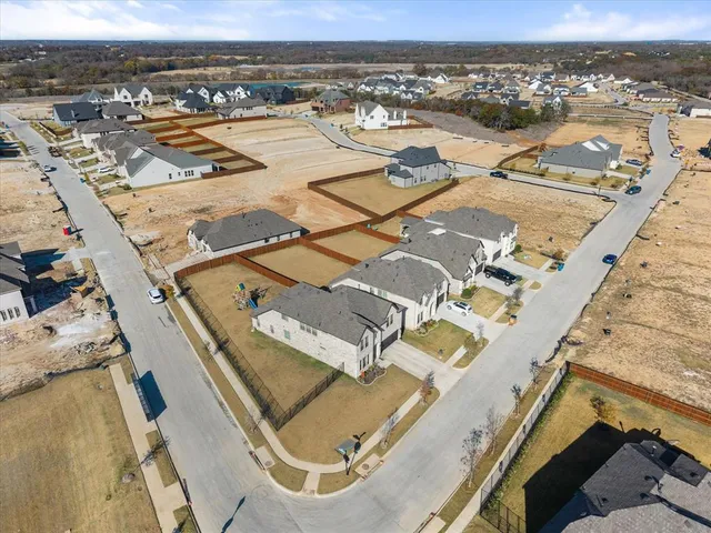 a view of a white house with a yard