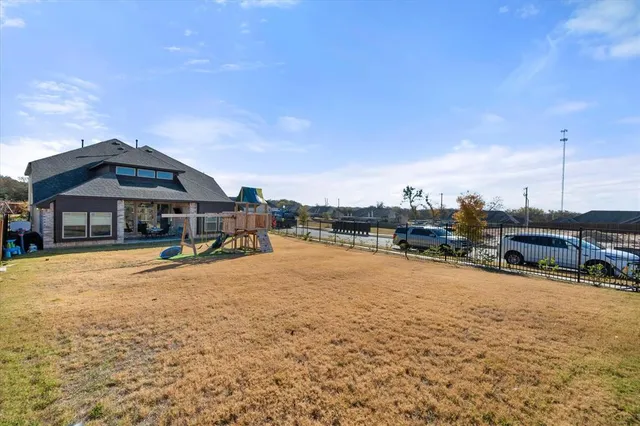 a swimming pool with outdoor seating and yard