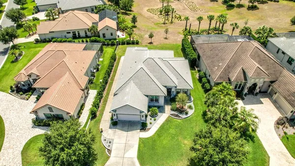 an aerial view of a house with yard swimming pool and outdoor seating