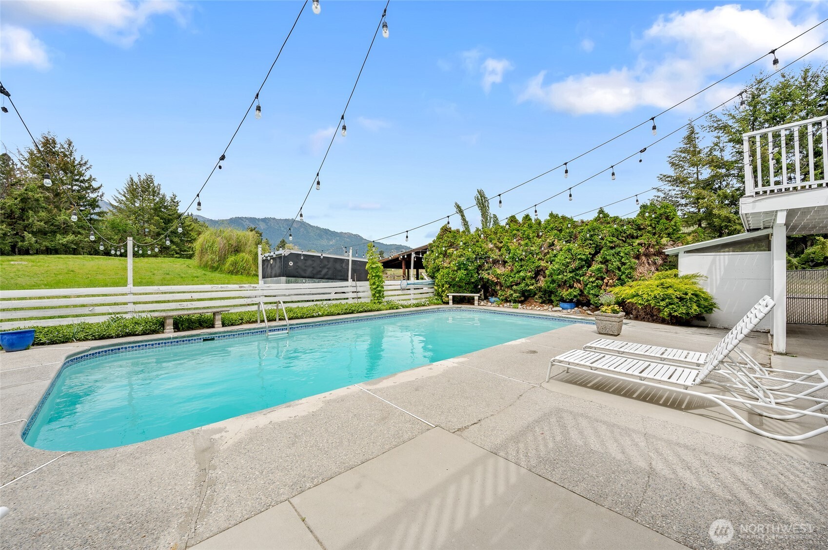 9656 North Road Peshastin, WA 98847 - Photo 35 of 40 a view of a swimming pool with a garden and plants