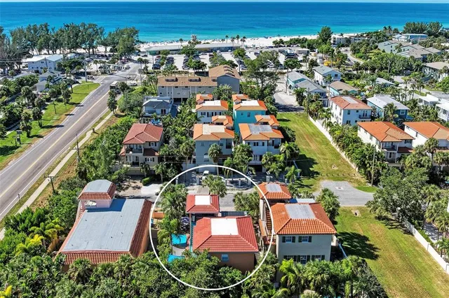 an aerial view of a house with a swimming pool yard and outdoor seating