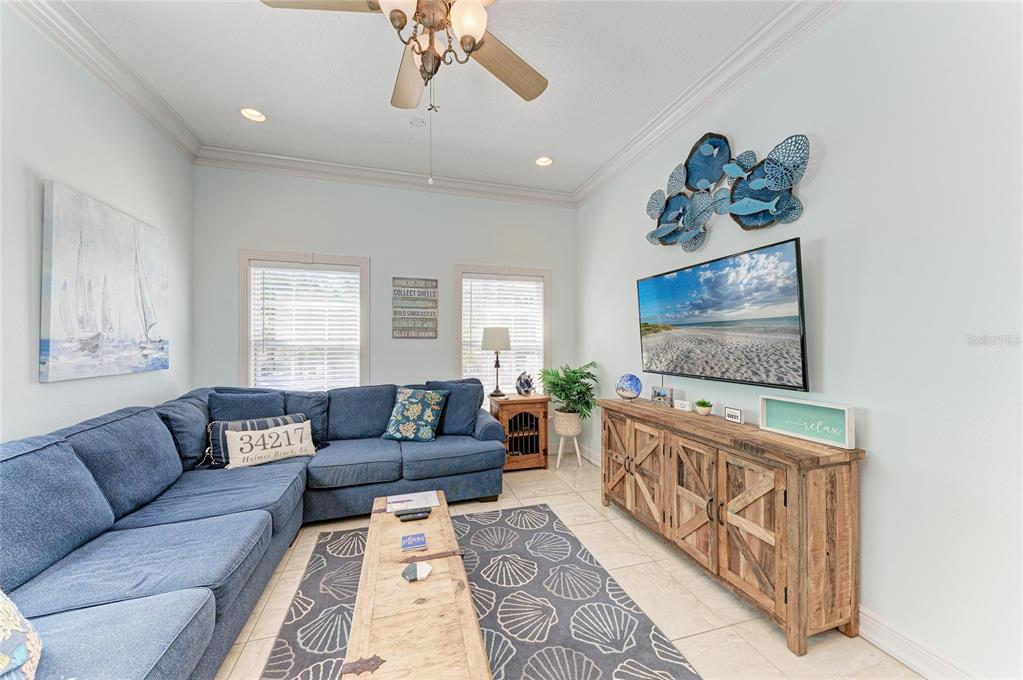 4003 5th Avenue Holmes Beach, FL 34217 - Photo 13 of 56 a living room with furniture and a flat screen tv