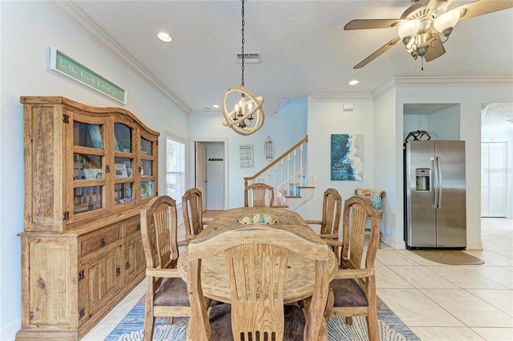 4003 5th Avenue Holmes Beach, FL 34217 - Photo 21 of 56 a dining room with furniture a chandelier and wooden floor