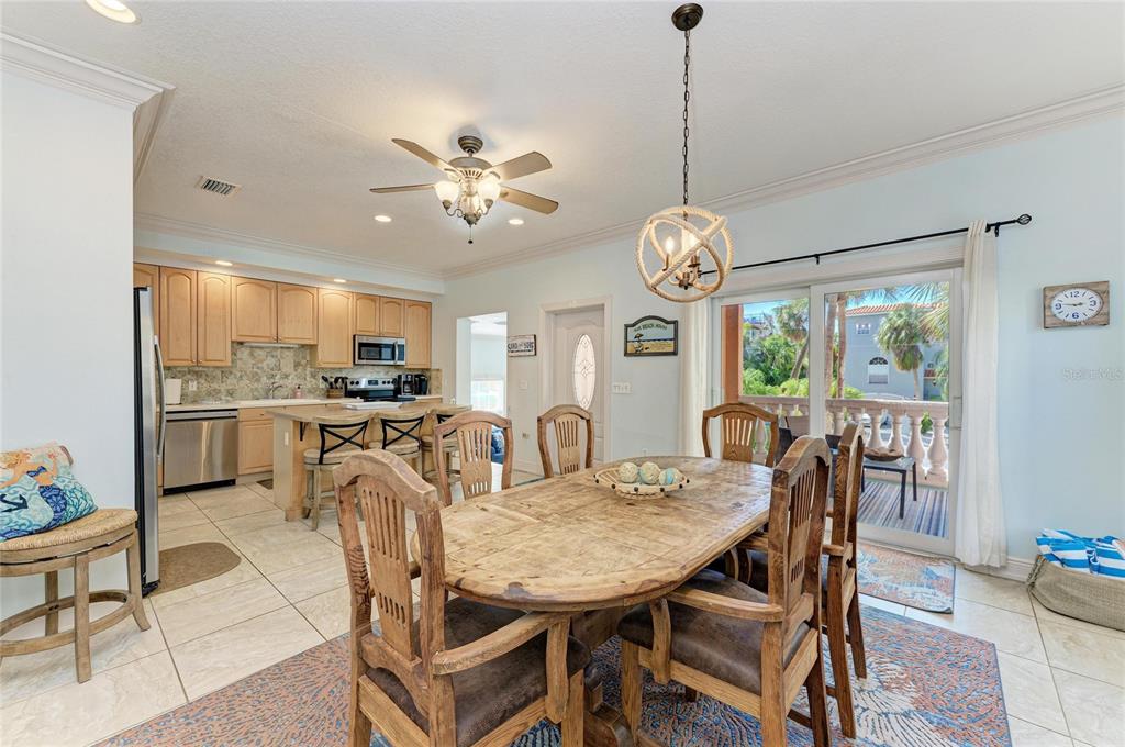 4003 5th Avenue Holmes Beach, FL 34217 - Photo 23 of 56 a view of a dining room and livingroom furniture a rug a chandelier and wooden floor