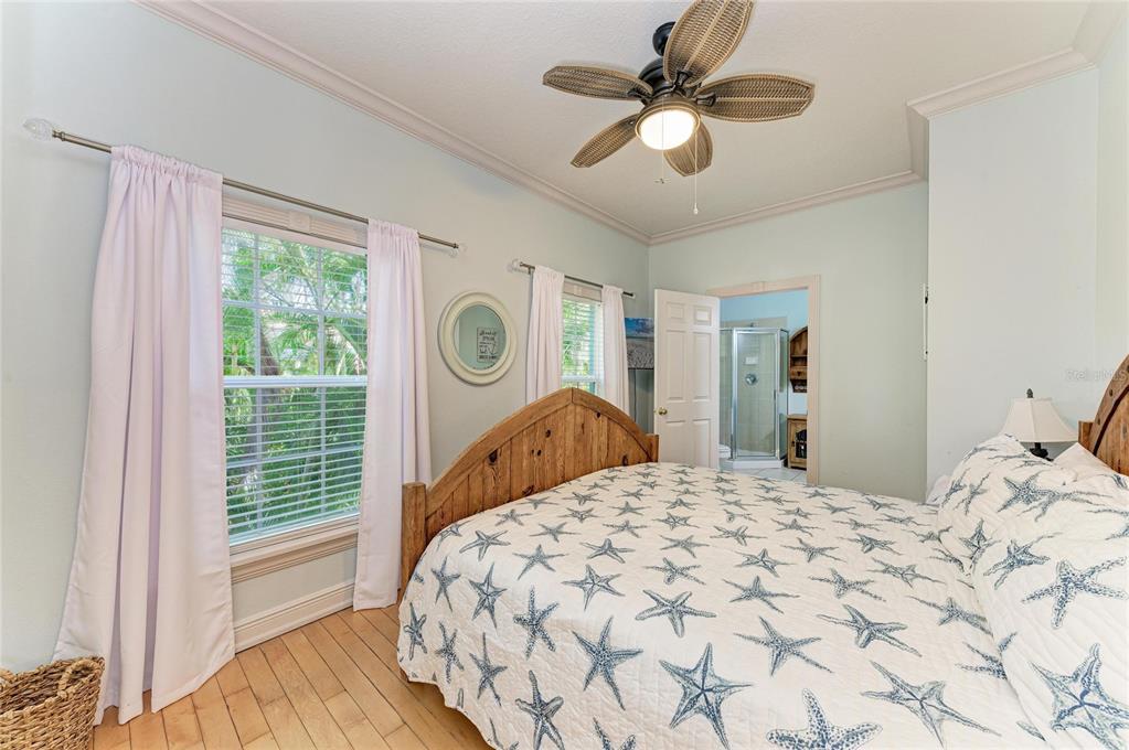4003 5th Avenue Holmes Beach, FL 34217 - Photo 24 of 56 a bedroom with a bed and a chandelier