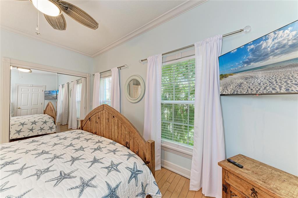 4003 5th Avenue Holmes Beach, FL 34217 - Photo 25 of 56 a bedroom with a bed and a window